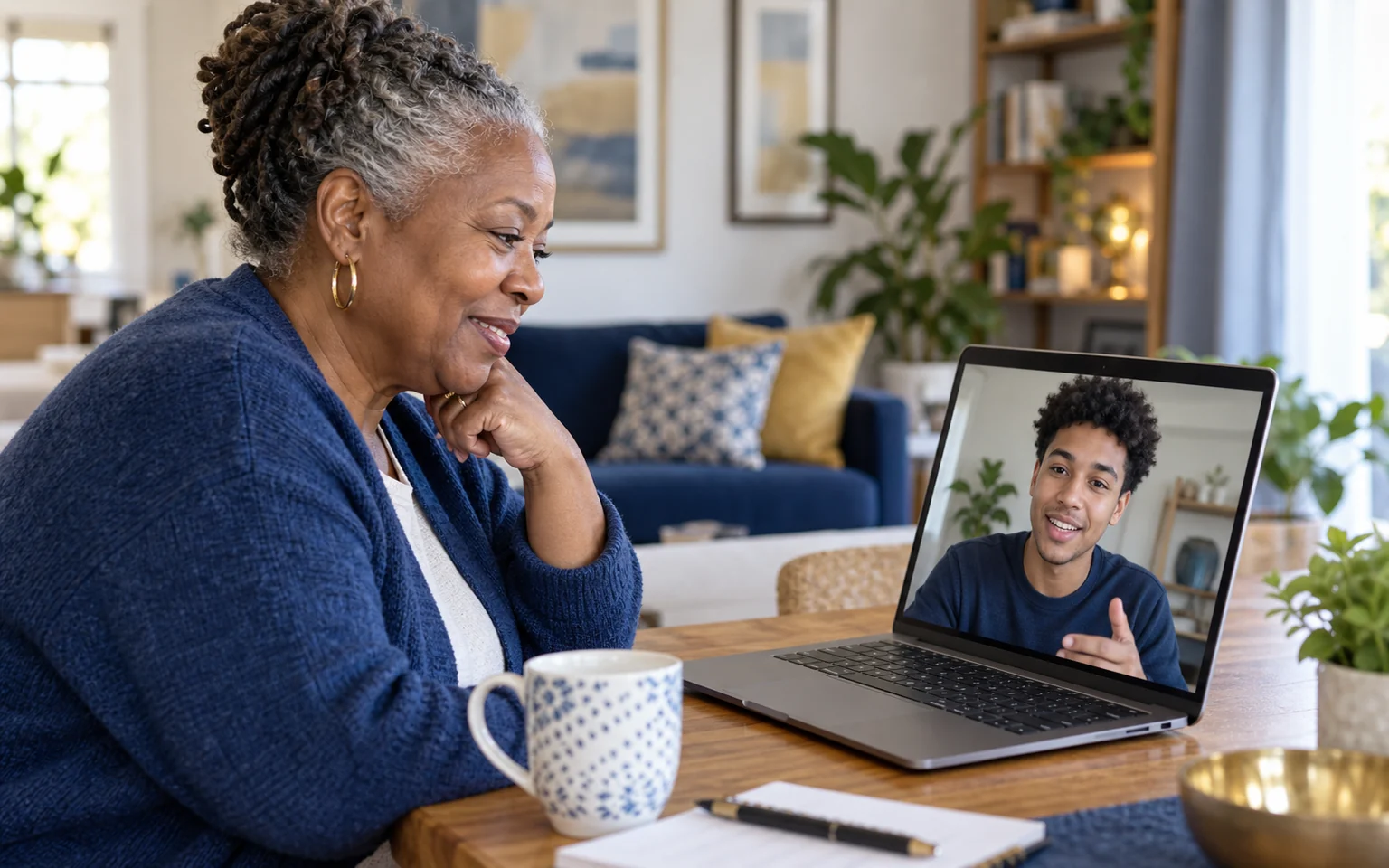 A Seasoned Adult receiving friendly video help from a young Tech Navigator.